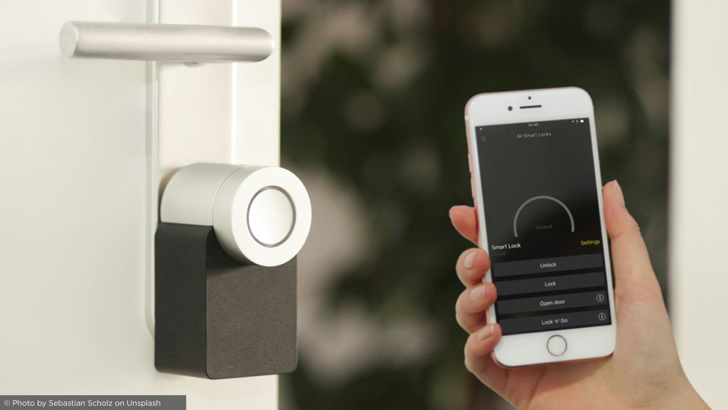 Smart lock being controlled via a mobile app for secure, keyless entry into a modern home, enhancing convenience and safety.
