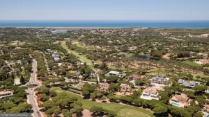 Aerial view of northern Quinta do Lago featuring luxury villas, golf fairways, and mature landscaping.