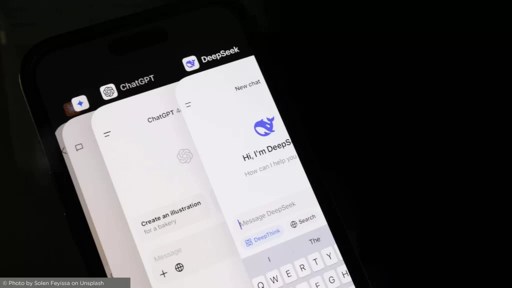 Smartphone screen displaying AI tools DeepSeek, ChatGPT, and Gemini on a web browser, representing artificial intelligence technology in real estate.