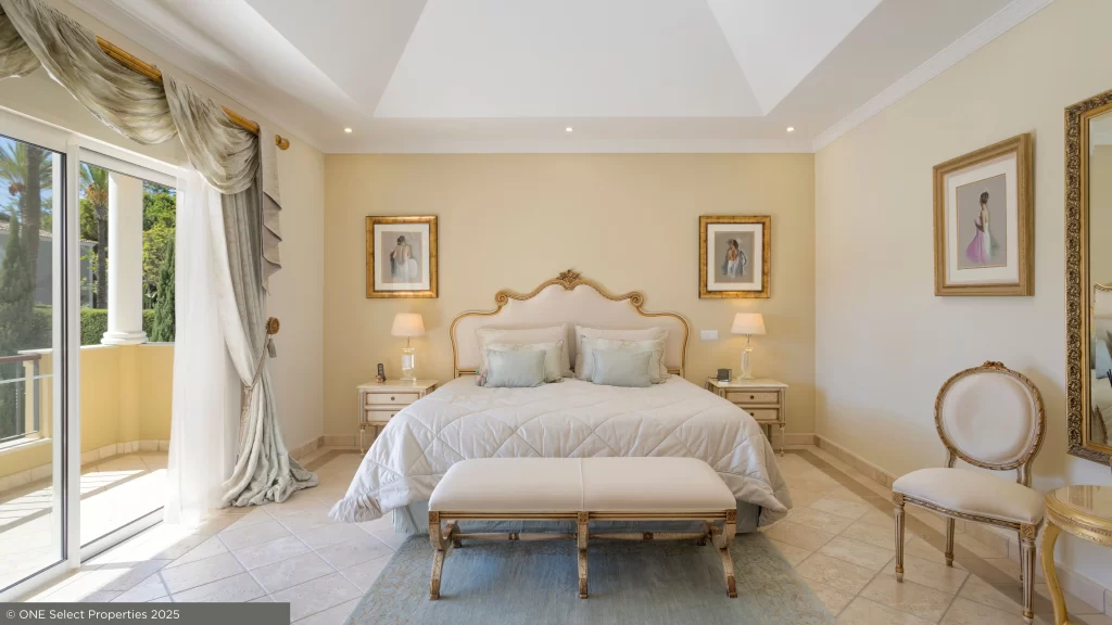 Master bedroom suite at Villa Nina with private terrace access and refined Algarve design elements.
