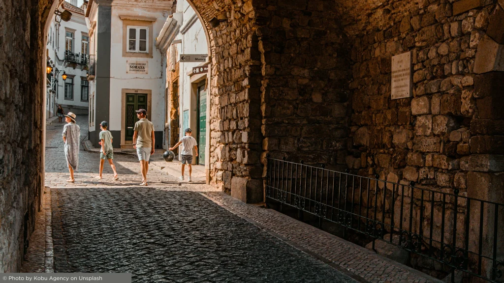 Family walking through Faro old town enjoying Algarve lifestyle