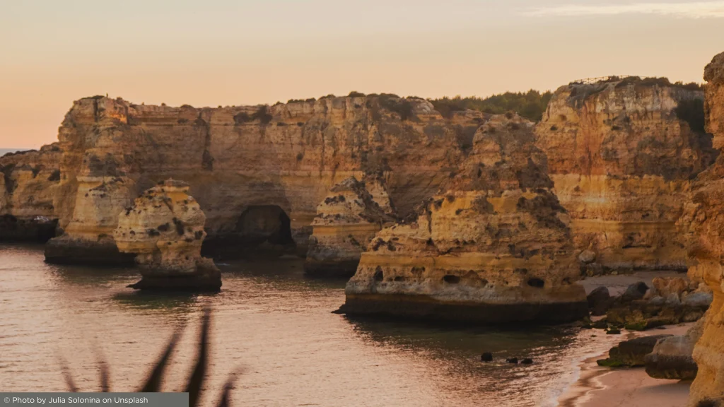 Sunset over Algarve cliffs with ocean views and warm coastal light