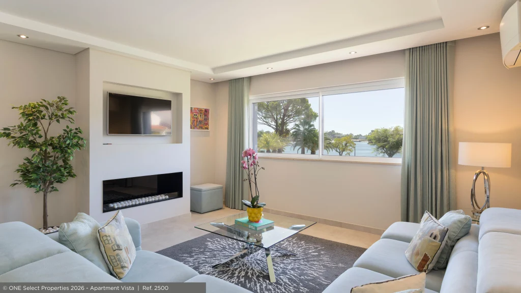 Contemporary living room at Apartment Vista with wide windows overlooking the lake in Varandas do Lago.