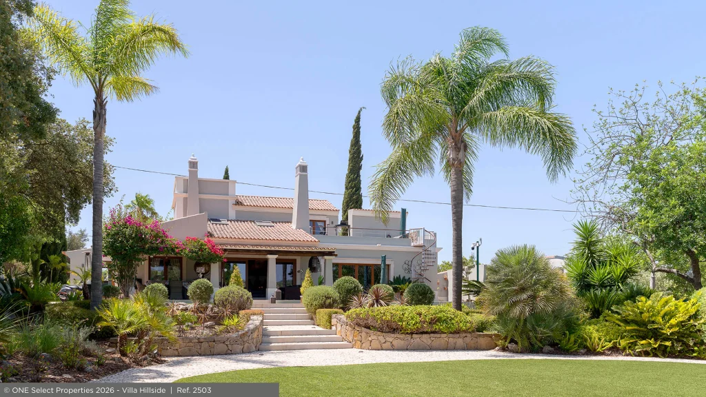 Landscaped gardens frame the traditional exterior of Villa Hillside in Santa Bárbara de Nexe.